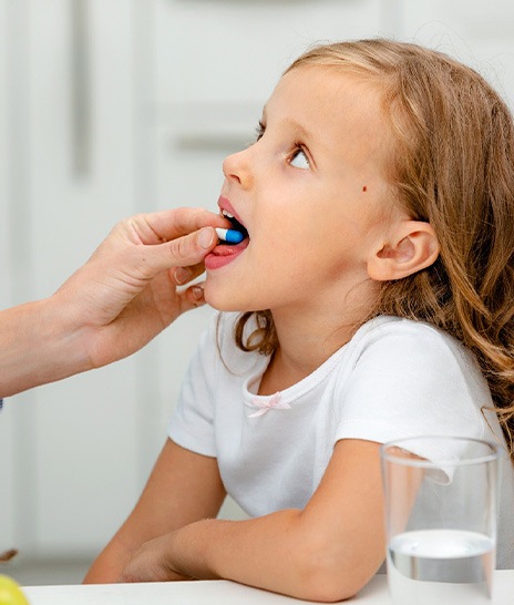A little girl taking an oral sedative