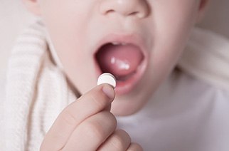 A little boy taking an oral sedative