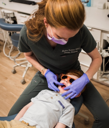 Young boy grinning in dental chair