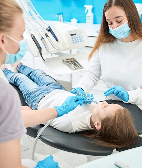 Dentist and hygienist placing a dental crown