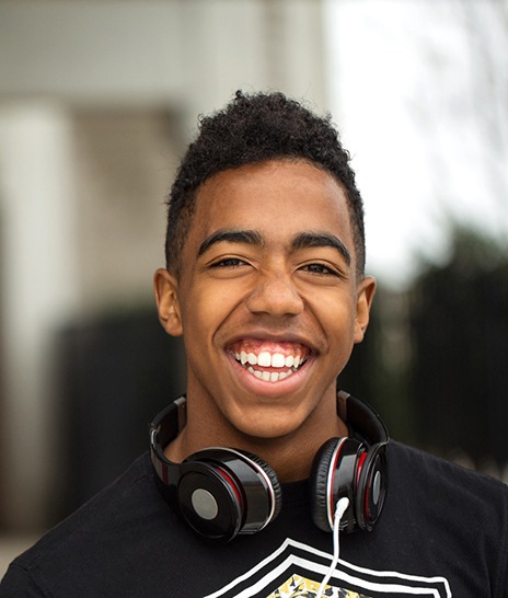 Happy male teenager smiling at school