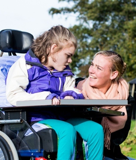 Mother talking to daughter in mobility chair