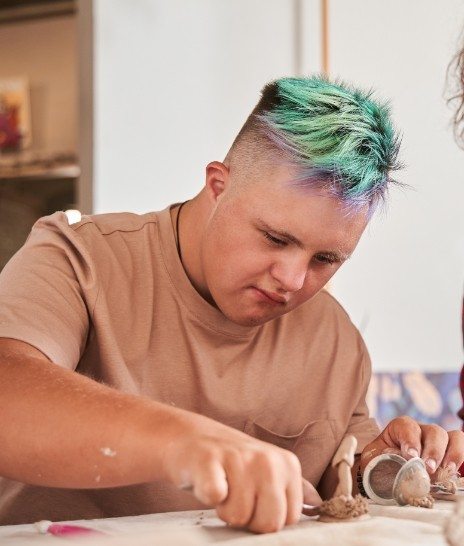 Boy sitting at table doing arts and crafts