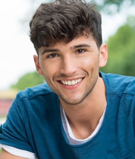 Smiling teen boy in dark blue shirt