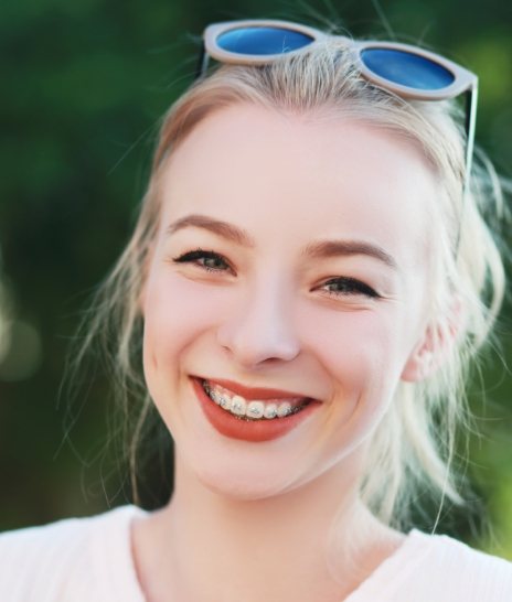 Smiling blonde teen girl with sunglasses