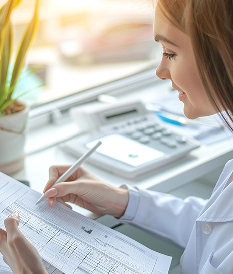 Dental staff member working on insurance paperwork