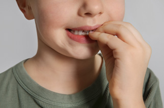Closeup of child biting their nails
