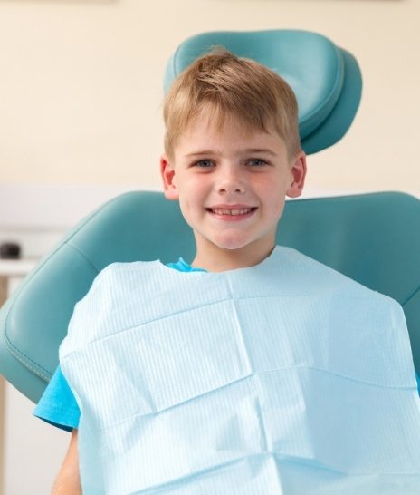 Young boy smiling in dental chair