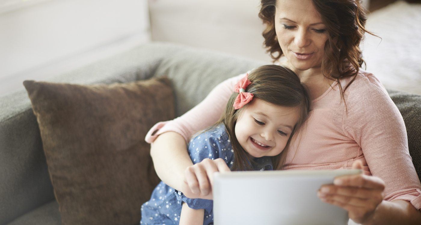 Mother and toddler looking at tablet together