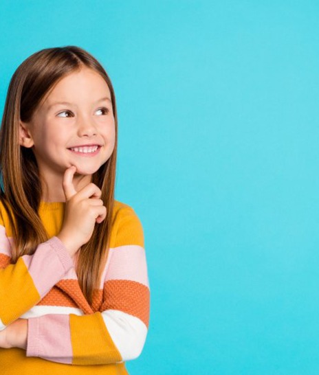 a girl smiling and touching her chin while thinking