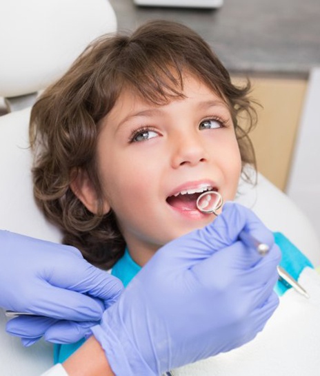 a child receiving dental care from his dentist