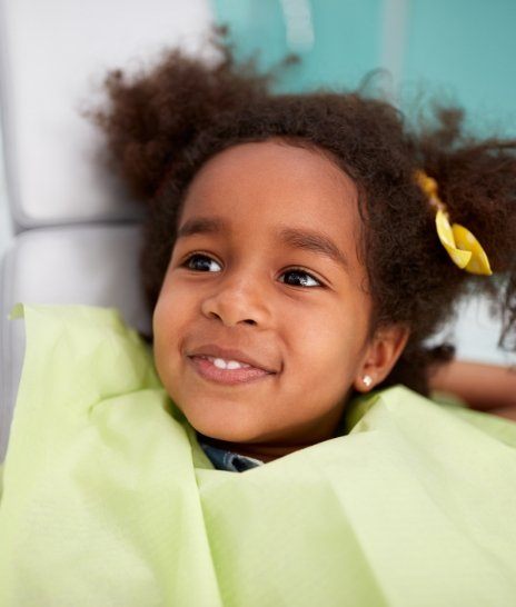 Young girl in dental chair while visiting Fort Worth pediatric dentist