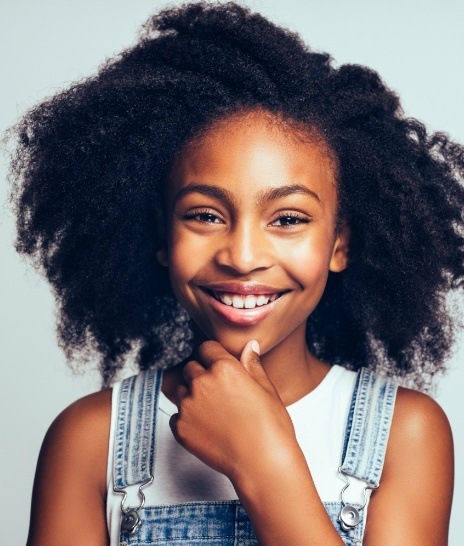 Smiling teenage girl wearing overalls