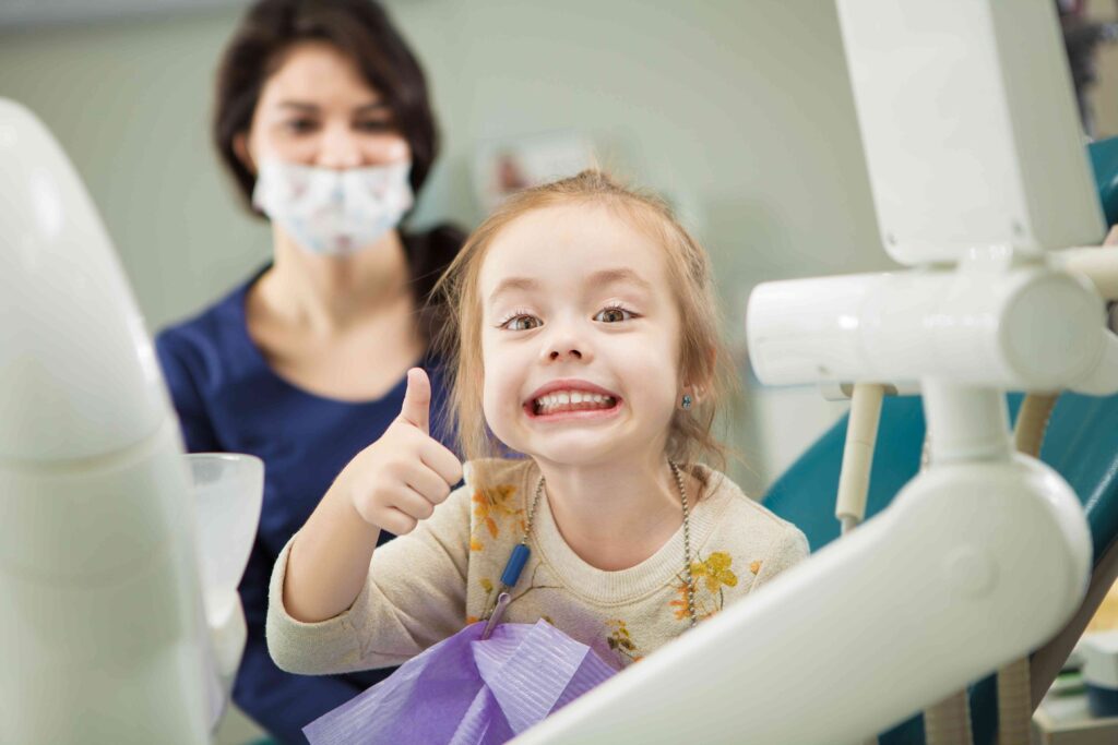 Child smiling in the dental chair