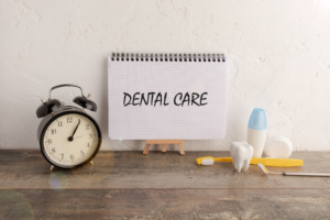 a dental insurance form by a clock