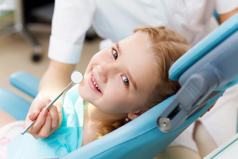 little girl seated in the treatment chair